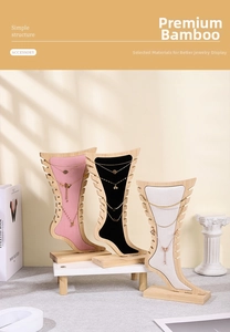 Bamboo jewelry stand with jagged grooves for displaying multiple necklaces in studio setting