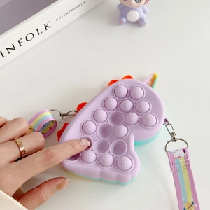 Close-up of fingers pressing bubbles on unicorn silicone crossbody fidget toy bag
