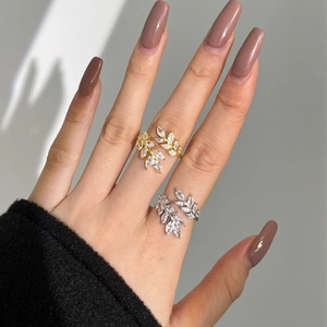 Close-up of S925 sterling silver leaf rings in gold and silver set with marquise zircon