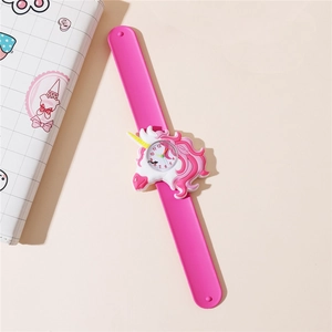 Close-up of pink unicorn slap watch with silicone strap and analog dial for kids