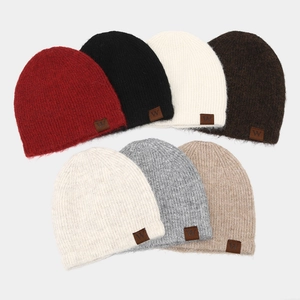 Set of seven striped knit beanie hats in various colors with a stylish leather logo