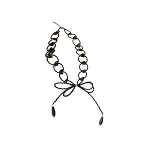 Y2K style black beaded necklace with bow tie accent and teardrop pendants