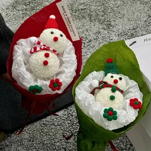 Handmade Christmas snowman flower bouquet with festive red and green knitted hats and scarves