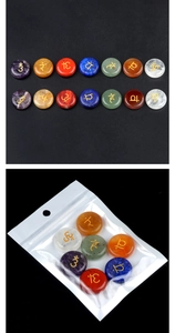 Close-up of seven chakra natural agate stones with gold engraved yoga symbols set