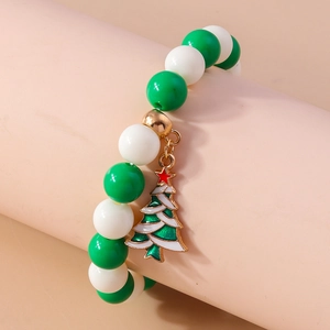 Detail of Christmas beaded bracelet featuring green tree charm and glossy white beads