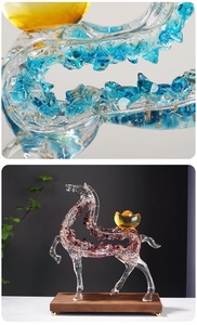 Macro shot of glass horse sculpture with gold foil details and purple-blue textures