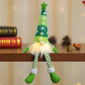 Detail of a glowing Christmas gnome plush with a green knit snowflake hat and lit beard