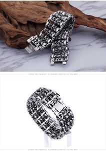Detail of silver skull link bracelet for men showing vintage punk texture and metal finish