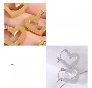 Detail of hollow heart hoop earrings in 18k gold and silver titanium steel finish