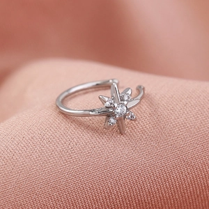 Macro shot of silver non-piercing star nose ring with inlaid clear gemstones