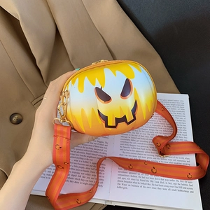 Detail of a mini pumpkin-shaped crossbody bag with a cartoon smiley face for Halloween