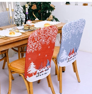 Detailed view of red and blue Christmas chair covers with gnome and snowflake patterns