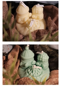 Primo piano di candele profumate bianco crema e verde menta con graziosi design cartoon