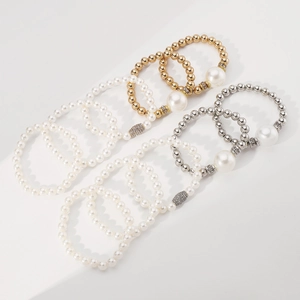 Detail of multi-row elastic pearl bracelets with gold and silver rhinestone beads