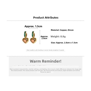 Detail view of heart drop earrings with pink zircons and gold copper finish and measurements