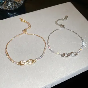 Elegant adjustable infinity knot bracelet set in gold and silver with sparkling zircon stones