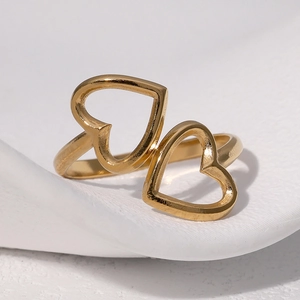Minimalist gold adjustable double heart stainless steel ring on elegant white ceramic