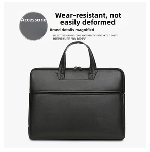 Detail of black matte leather laptop bag with high-quality stitching and dual handles