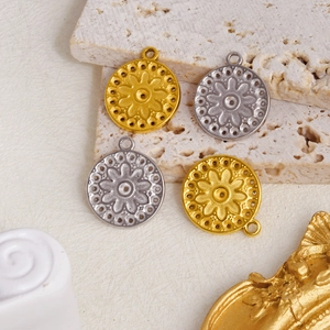 Detail view of 304 stainless steel embossed flower pendants in gold and silver