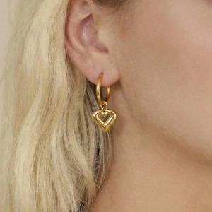 18k gold plated stainless steel hoop earrings with 3D hollow heart charms on female model