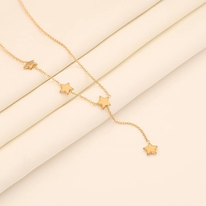 Detailed shot of golden Y-shaped stainless steel necklace with five-pointed star pendants