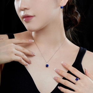 Detailed view of model wearing a luxury blue square zircon necklace and earring set
