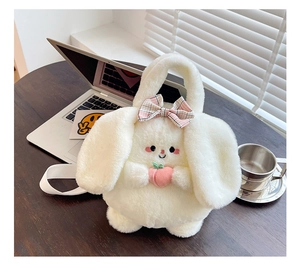 Detail of a white plush bunny shoulder bag featuring a pink bow and peach accessory