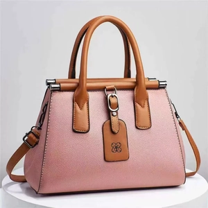 Elegant pink litchi grain women's handbag with brown handles and shoulder strap