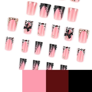 Pink and black Y2K duckbill false nails with 3D bows, leopard print, and sparkling rhinestones
