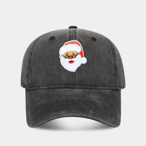 Close-up of a black washed cotton baseball cap with embroidered cartoon Santa Claus patch