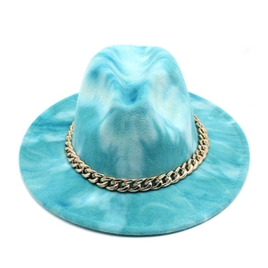 Detail of blue tie-dye wool fedora hat featuring a chunky gold metal chain decoration