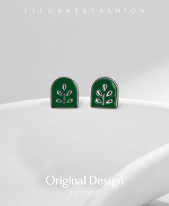 Detail of s925 silver botanical stud earrings with green enamel and leaf texture