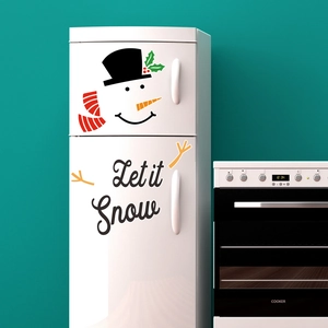 Detail of Christmas snowman magnetic stickers with Let it Snow text on refrigerator