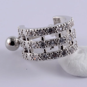 Macro detail of silver stainless steel cartilage stud earring with triple row zirconia