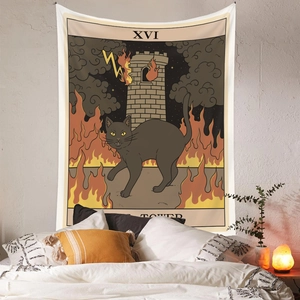 Detail of bohemian black cat tarot tapestry showing the tower motif in warm bedroom