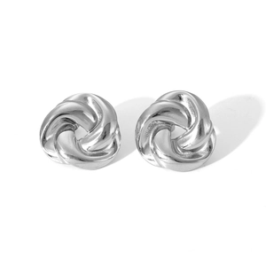 Close-up of silver stainless steel earrings with intricate twisted knot design detail