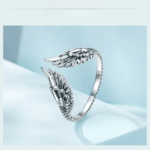 Macro shot of S925 sterling silver wing ring showing detailed feather texture