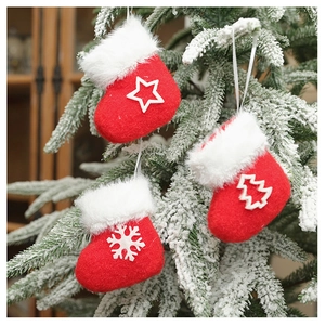 Detail of red plush Christmas stocking ornaments with star and snowflake patterns on a tree
