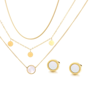 Detailed view of triple-layered gold necklaces with white shell pendants and stud earrings