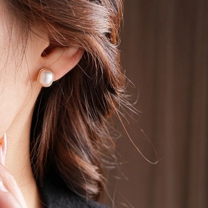 French retro square pearl earrings with gold-plated edges on a female model