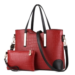 Deep red crocodile embossed tote bag and matching clutch set with black straps