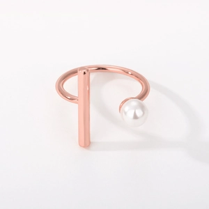 Detail of rose gold adjustable ring with white pearl and vertical geometric metal bar