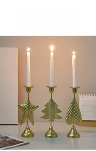 Detailed view of heart, star, and tree-shaped gold metal candle holders with spiral candles