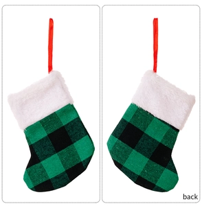 Front and back detail of green buffalo plaid Christmas stockings with white faux fur trim