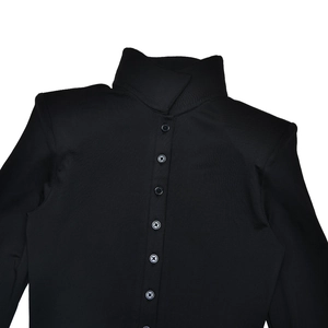 Close-up of black long-sleeve knit top featuring a stylish polo collar and front buttons