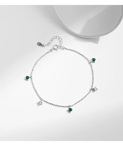 Detailed macro shot of S925 sterling silver clasp with emerald green stone and tassels