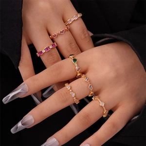 Detailed view of gold-plated rings featuring colorful heart and clover zircon settings