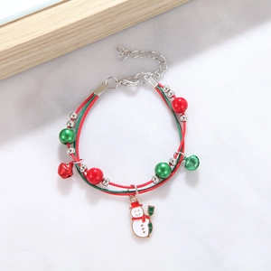 Christmas snowman charm bracelet with red and green beads on a white marble background