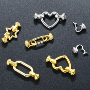 Close-up of gold and silver heart, star, and oval necklace connector clasps for jewelry