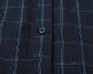 Detail of navy blue plaid cotton shirt placket with classic button-down fastening